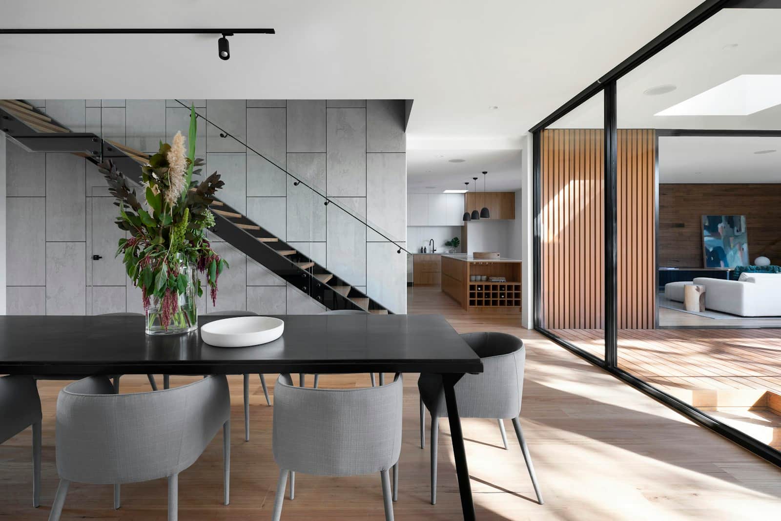 Dining space beside an open staircase